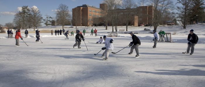Image of students playing ice hockey on Swan Lake, UConn Storrs Campus.